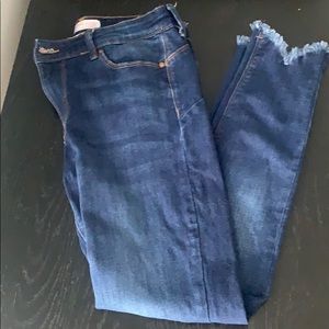 A skinny jean with shreds at bottom